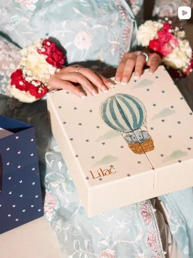 Lilac Mithai Studio Instagram post: Hot-air-balloon gift box held at a celebration