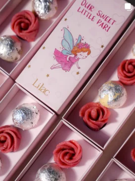Lilac Mithai Studio Instagram post: Pink "Our sweet little pari" boxes with rose-shaped sweets
